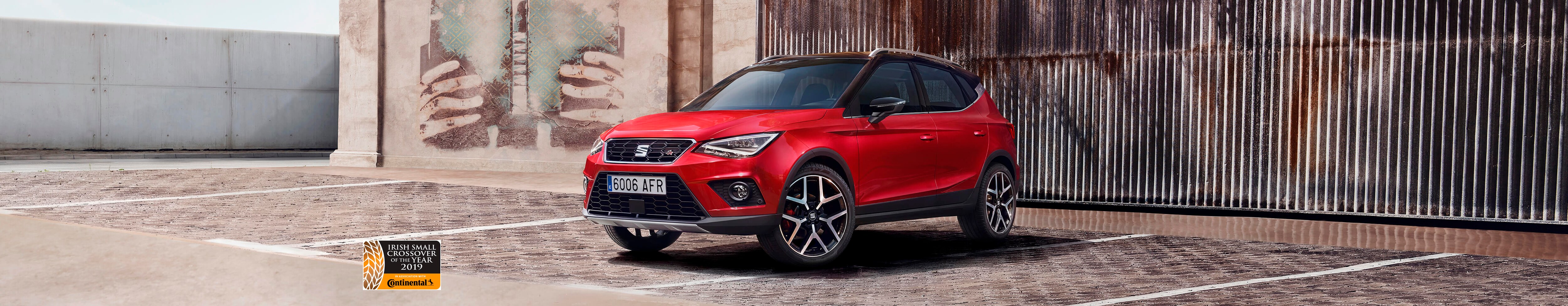 desire red SEAT Arona outdoor side angle view