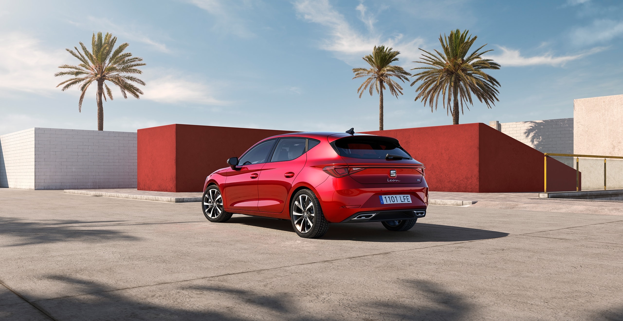 Three-quarter rear side view of a red SEAT Leon.